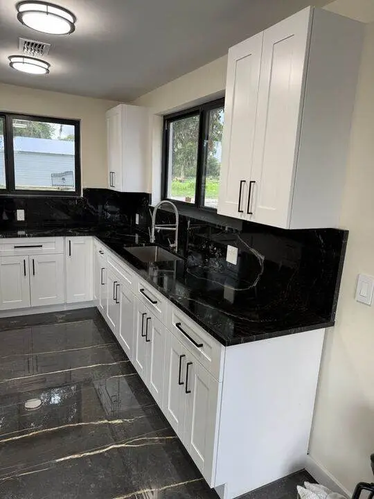 White cabinets with black granite countertops