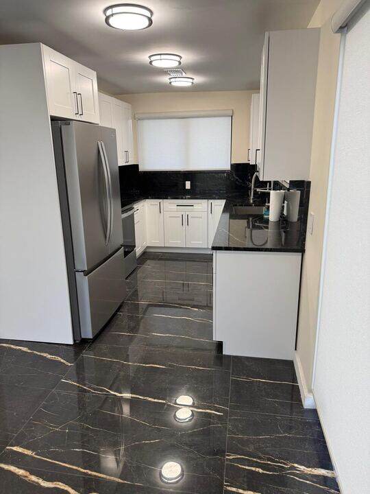 Kitchen with black granite countertops