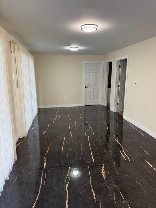 Living room with black marble tile floor