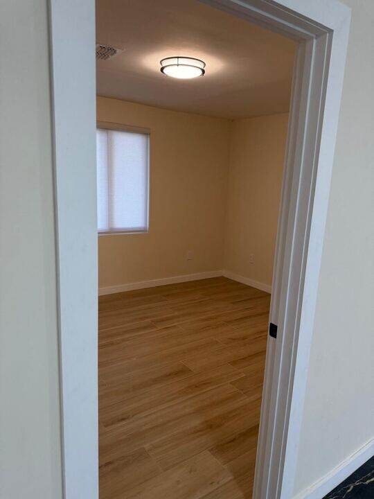 Bedroom with wood flooring